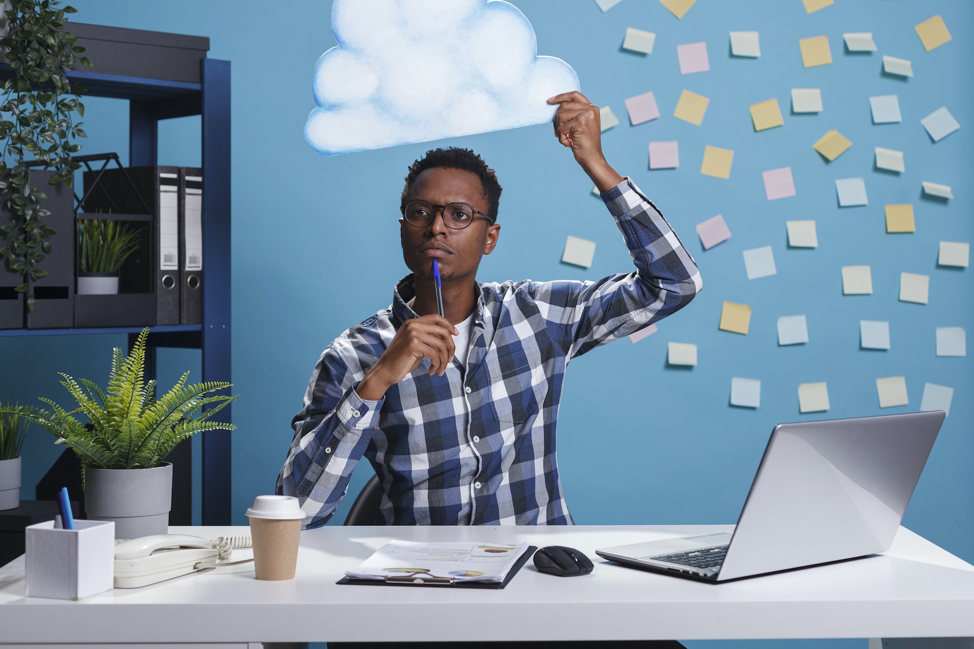 Thoughtful and focused entrepreneur with cloud bubble above head while thinking about right business